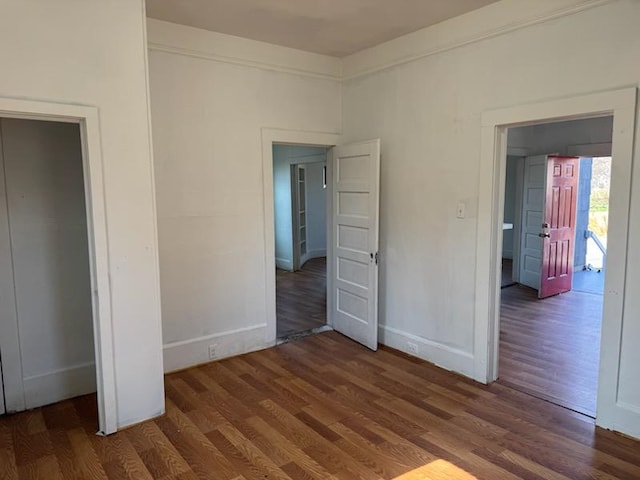 unfurnished bedroom with dark hardwood / wood-style floors