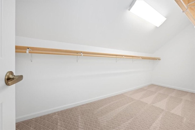 spacious closet featuring carpet flooring and vaulted ceiling