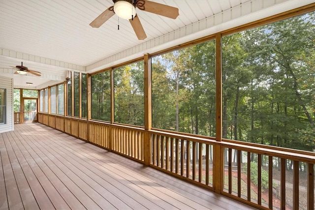 unfurnished sunroom featuring ceiling fan