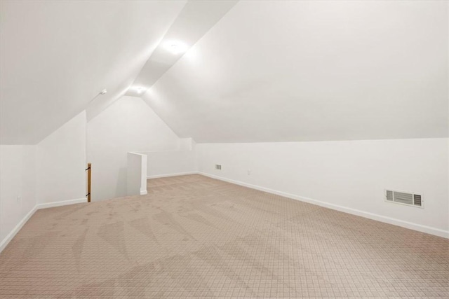 bonus room with vaulted ceiling, carpet flooring, visible vents, and baseboards