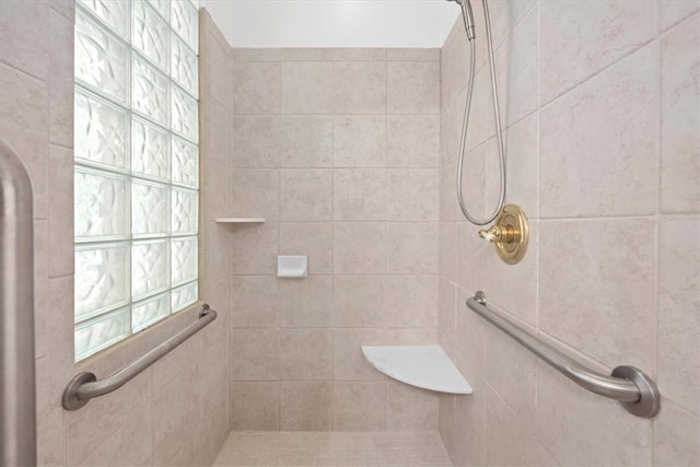 bathroom with a tile shower