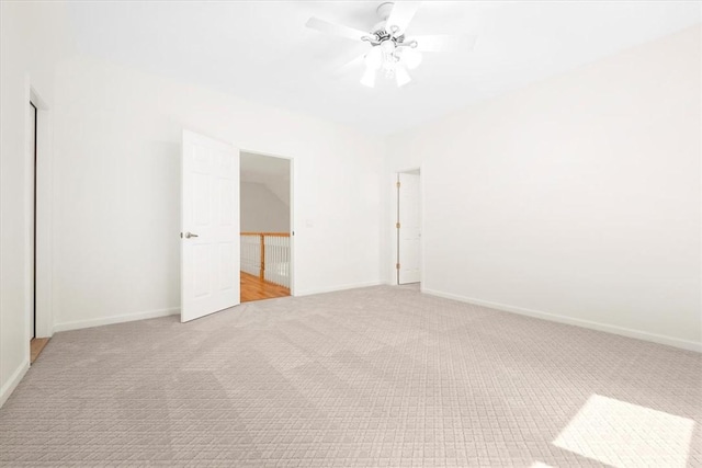 unfurnished bedroom featuring a ceiling fan, light carpet, and baseboards