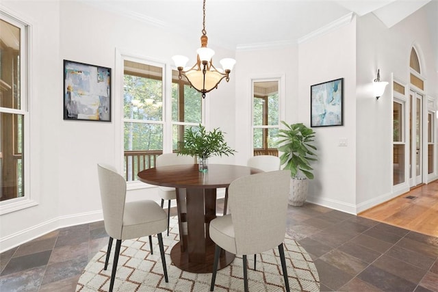 dining area featuring ornamental molding, plenty of natural light, and baseboards