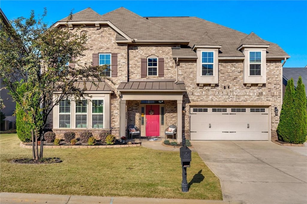 view of front of home featuring a garage and a front yard