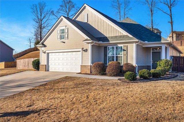 view of front of property featuring a garage and a front lawn