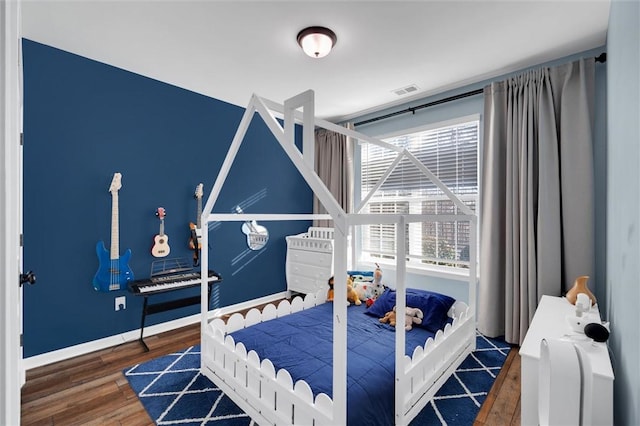 bedroom with dark wood-type flooring