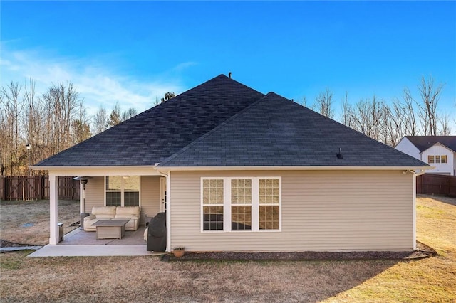 rear view of property featuring an outdoor living space, a yard, and a patio area