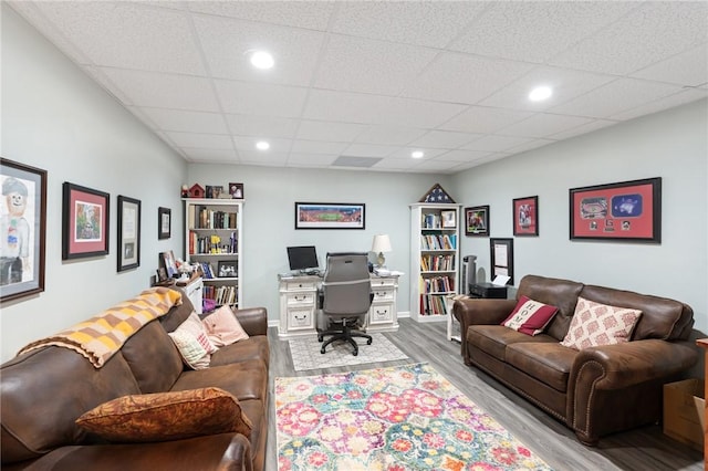 office area featuring a drop ceiling and light wood-type flooring