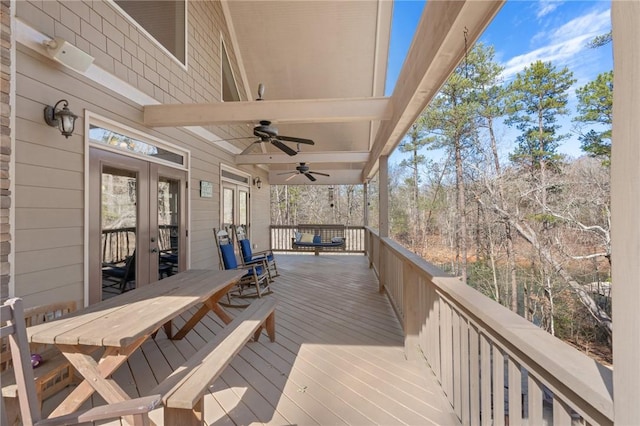 wooden deck featuring ceiling fan and french doors