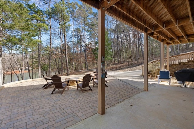 view of patio with an outdoor fire pit and a grill