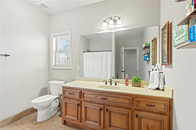 bathroom with vanity, tile patterned flooring, and toilet