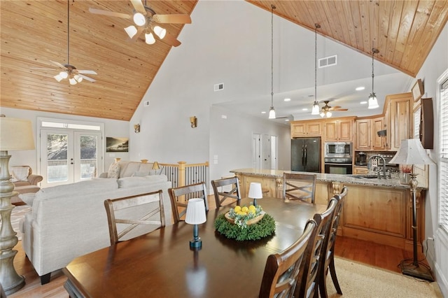 dining area featuring french doors, sink, high vaulted ceiling, wooden ceiling, and light hardwood / wood-style floors