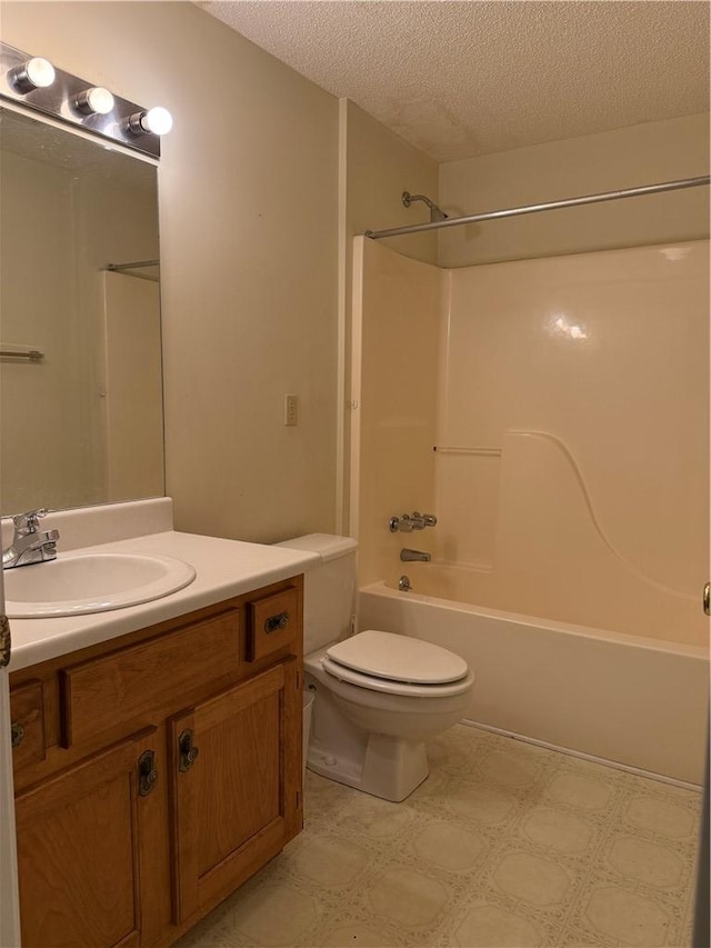 full bathroom with vanity, toilet, tub / shower combination, and a textured ceiling