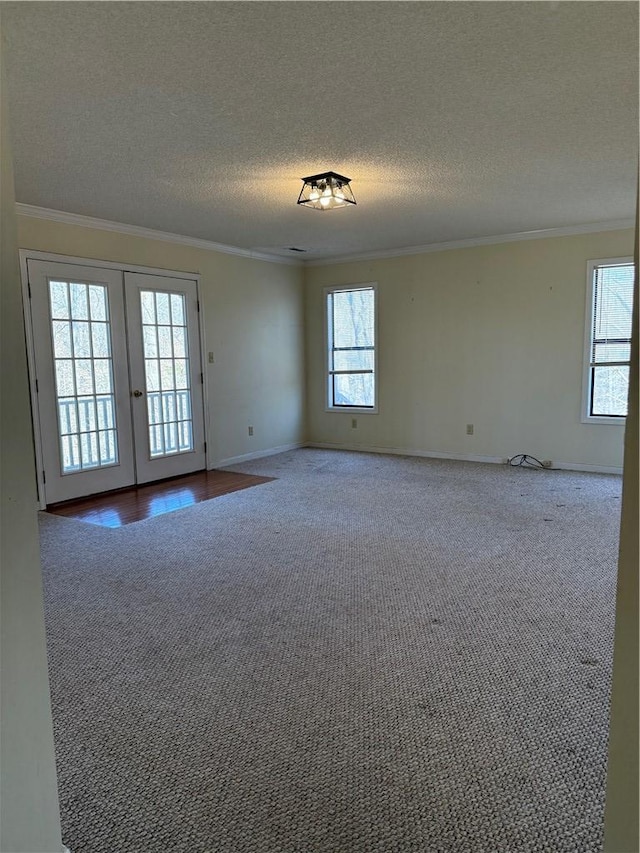 spare room featuring ornamental molding, a healthy amount of sunlight, and french doors