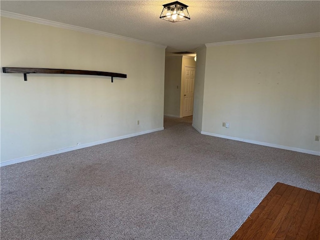 carpeted spare room featuring crown molding and a textured ceiling