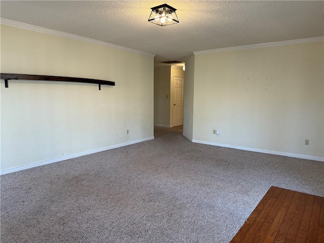 carpeted spare room featuring crown molding and a textured ceiling