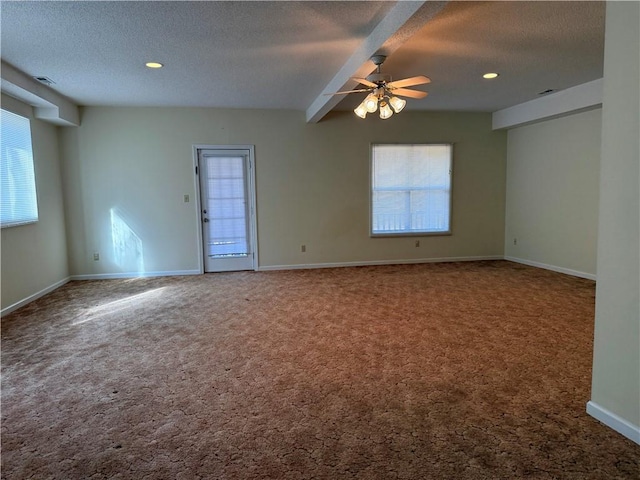 spare room featuring ceiling fan, carpet, and a textured ceiling