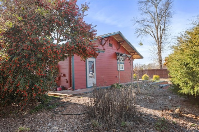 view of outbuilding featuring fence