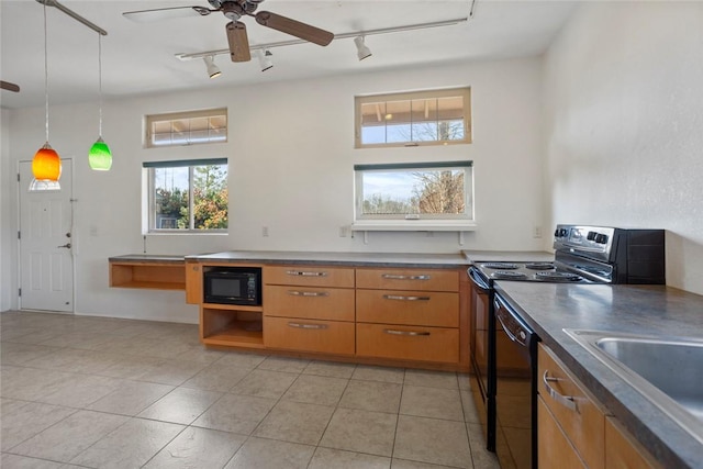 kitchen with sink, hanging light fixtures, light tile patterned floors, ceiling fan, and black appliances