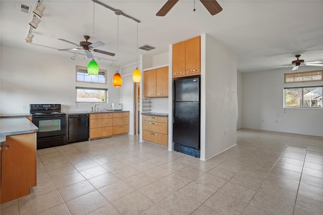 kitchen with pendant lighting, ceiling fan, black appliances, and a healthy amount of sunlight