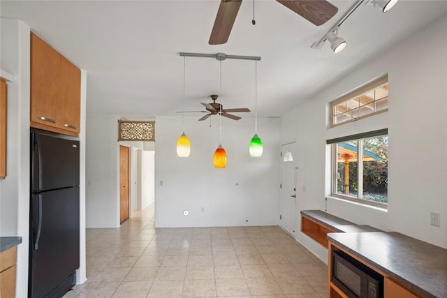 kitchen with light tile patterned flooring, rail lighting, hanging light fixtures, ceiling fan, and black appliances