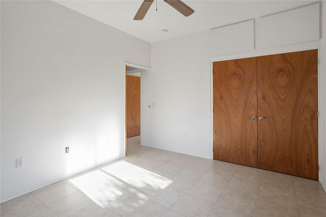 unfurnished bedroom featuring ceiling fan and a closet