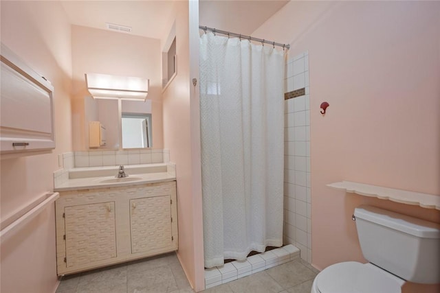 bathroom with vanity, curtained shower, tile patterned floors, and toilet