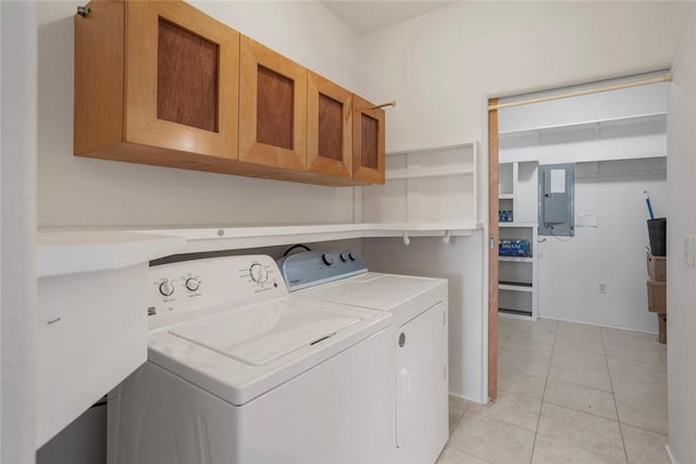 clothes washing area featuring cabinets, light tile patterned floors, electric panel, and independent washer and dryer