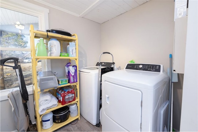 laundry room featuring hardwood / wood-style flooring, washing machine and dryer, and wooden ceiling