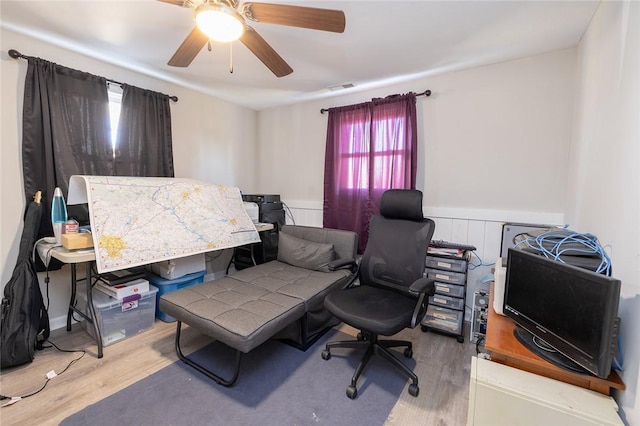 office with hardwood / wood-style flooring and ceiling fan