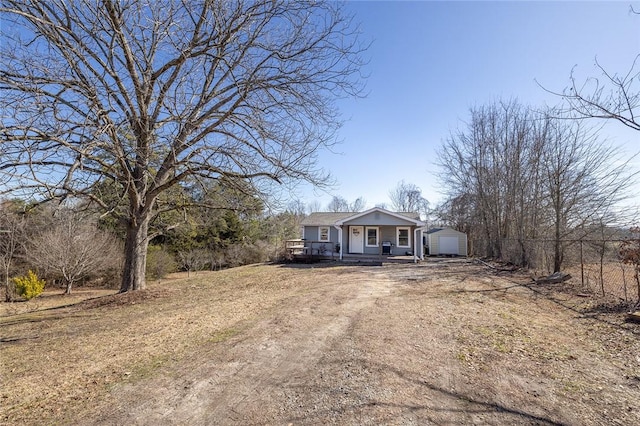 ranch-style home featuring an outbuilding, a garage, and covered porch