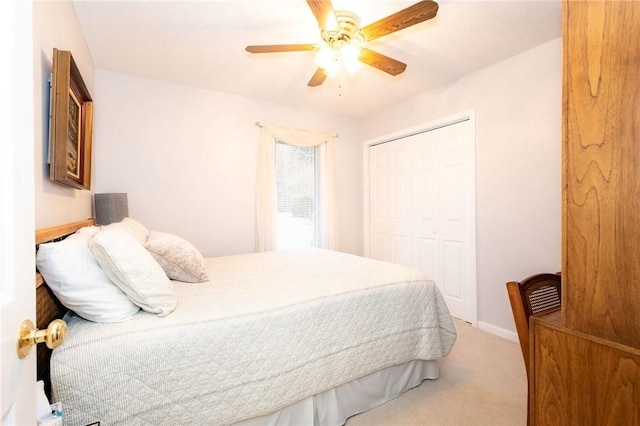 carpeted bedroom with a closet and ceiling fan