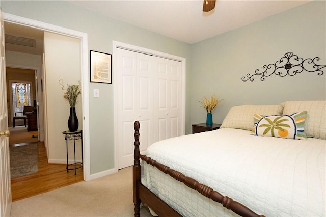 bedroom with a closet, ceiling fan, and carpet flooring