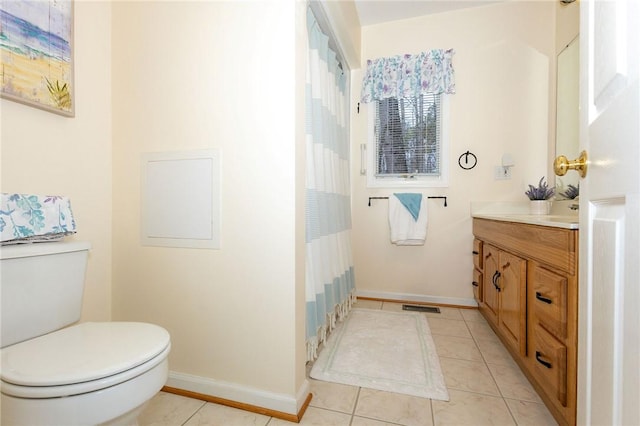 bathroom with tile patterned flooring, vanity, a shower with curtain, and toilet