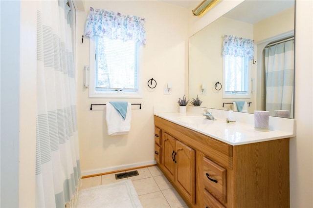 bathroom featuring tile patterned flooring and vanity