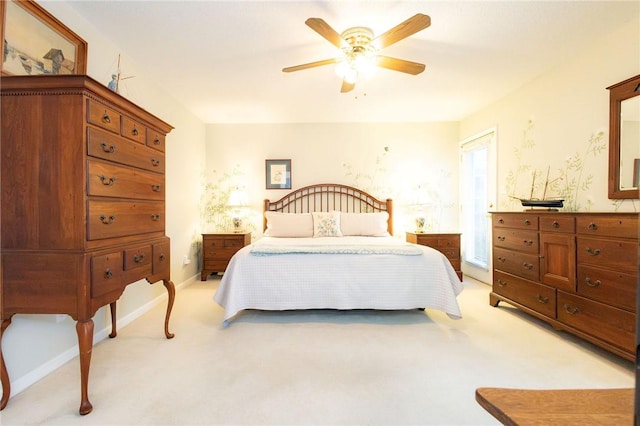 bedroom featuring light colored carpet and ceiling fan