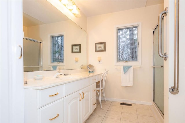 bathroom with vanity, a shower with door, and tile patterned flooring