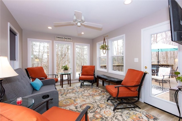 living room with ceiling fan and light hardwood / wood-style flooring