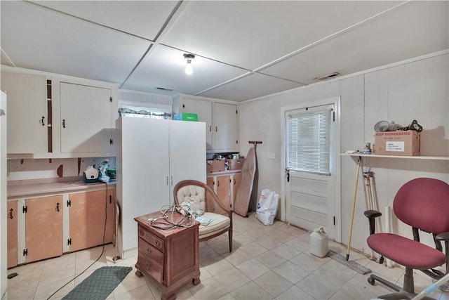 kitchen with white cabinetry and light tile patterned floors