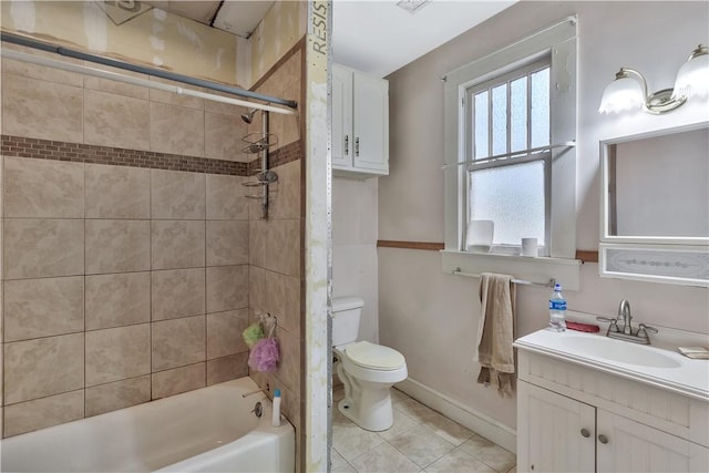 full bathroom featuring tiled shower / bath, vanity, toilet, and tile patterned flooring