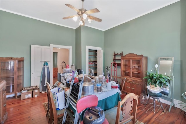 dining space featuring ceiling fan, ornamental molding, and wood-type flooring