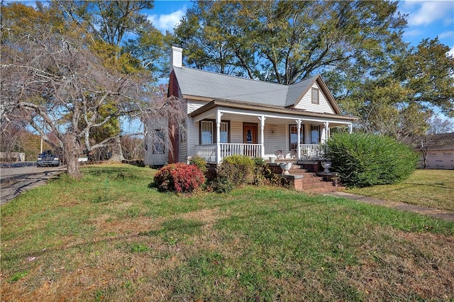 view of front of house with a porch and a front lawn