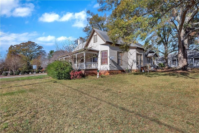 view of home's exterior with a porch and a lawn