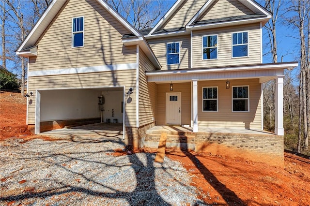 view of front of house with driveway, a garage, and a porch