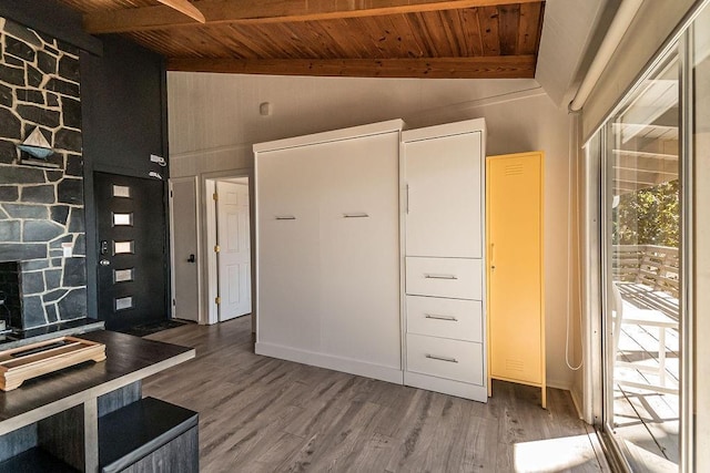 foyer featuring wood ceiling, hardwood / wood-style floors, and vaulted ceiling with beams