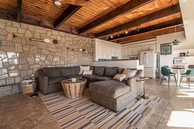 tiled living room with ceiling fan, track lighting, wooden ceiling, and beamed ceiling