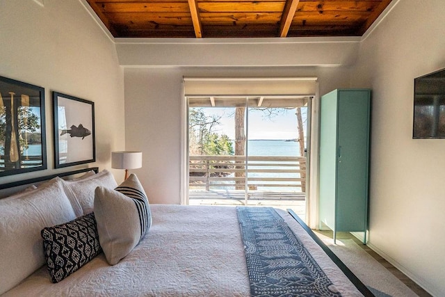 bedroom featuring beamed ceiling, carpet floors, and wooden ceiling