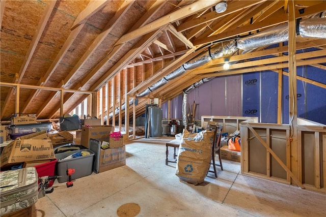 unfinished attic featuring water heater