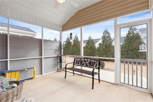 sunroom with ceiling fan and vaulted ceiling