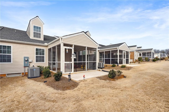 back of house featuring central AC and a sunroom